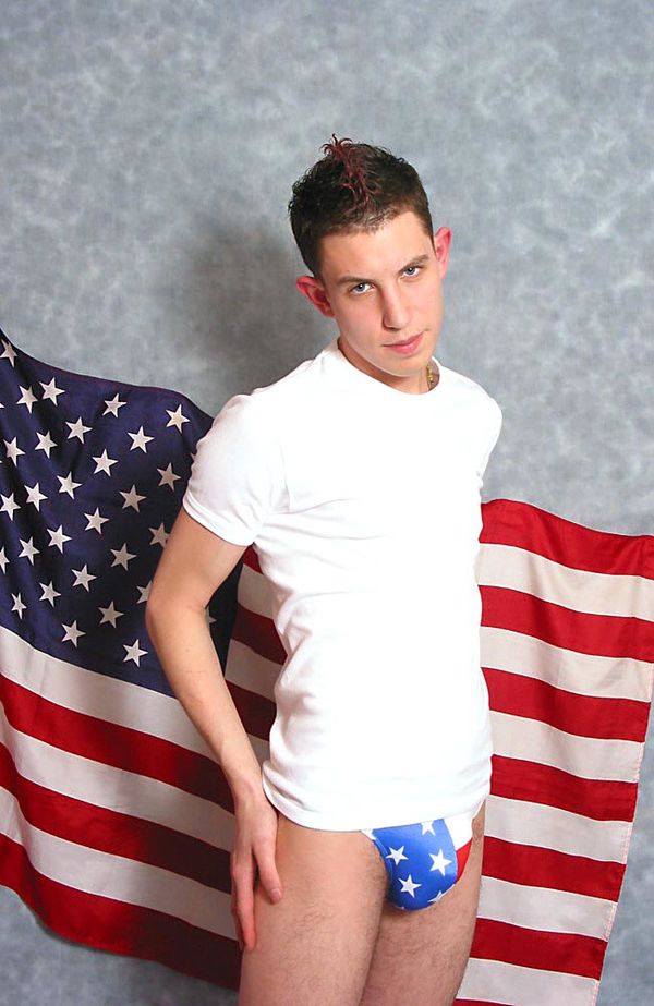 American boy do seductive pose in front of his national flag