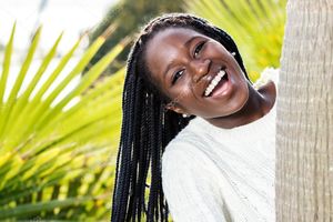 Happy african teen with braids. - Stock