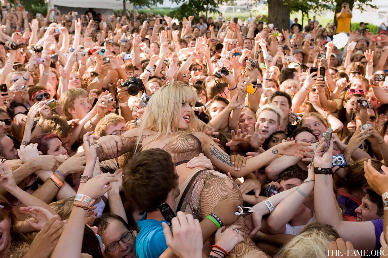 Lady Gaga crowd surfing at Lollapalooza wearing just fishnet