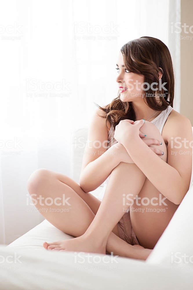 Beautiful Teenage Fashion Model Sitting On Sofa Stock Photo