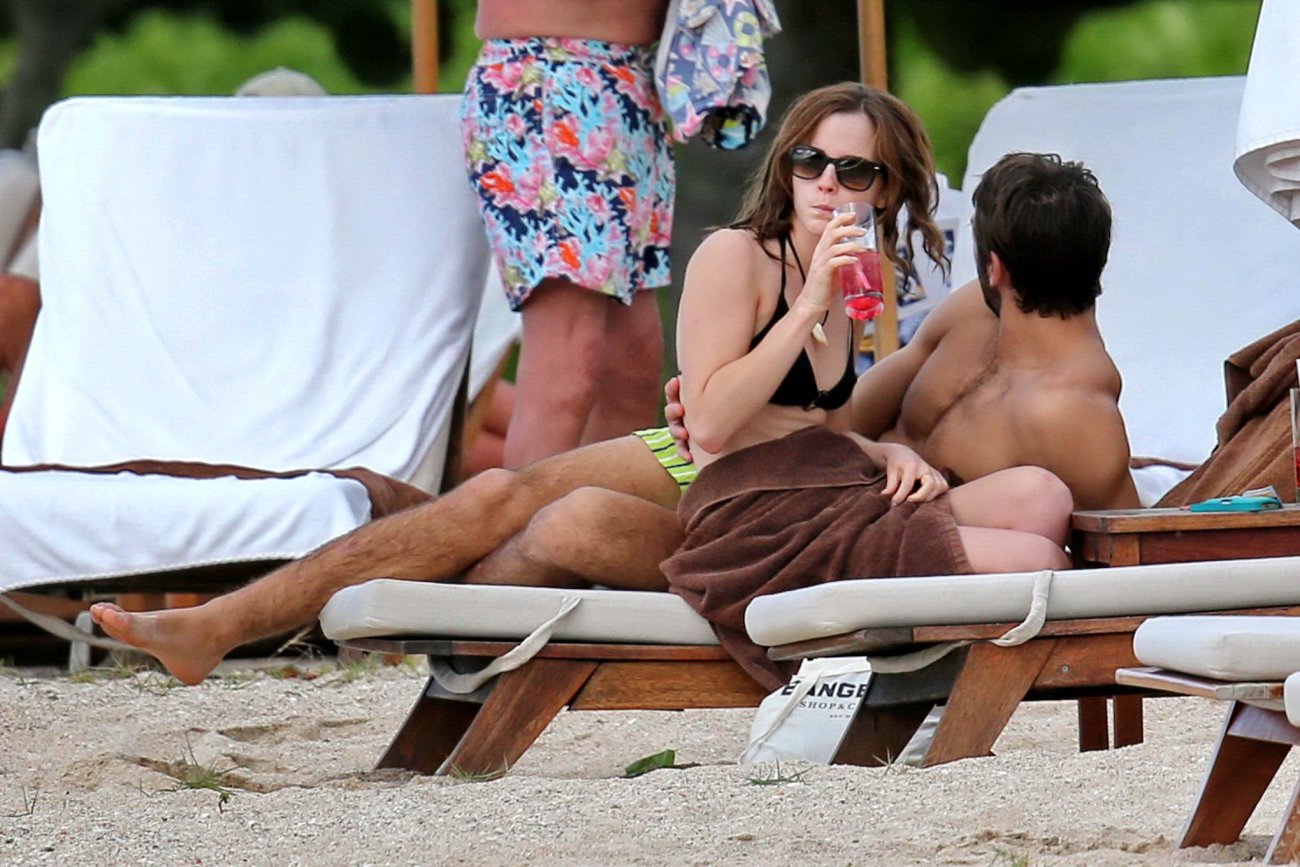 Emma Watson in black bikini petting with her boyfriend on a